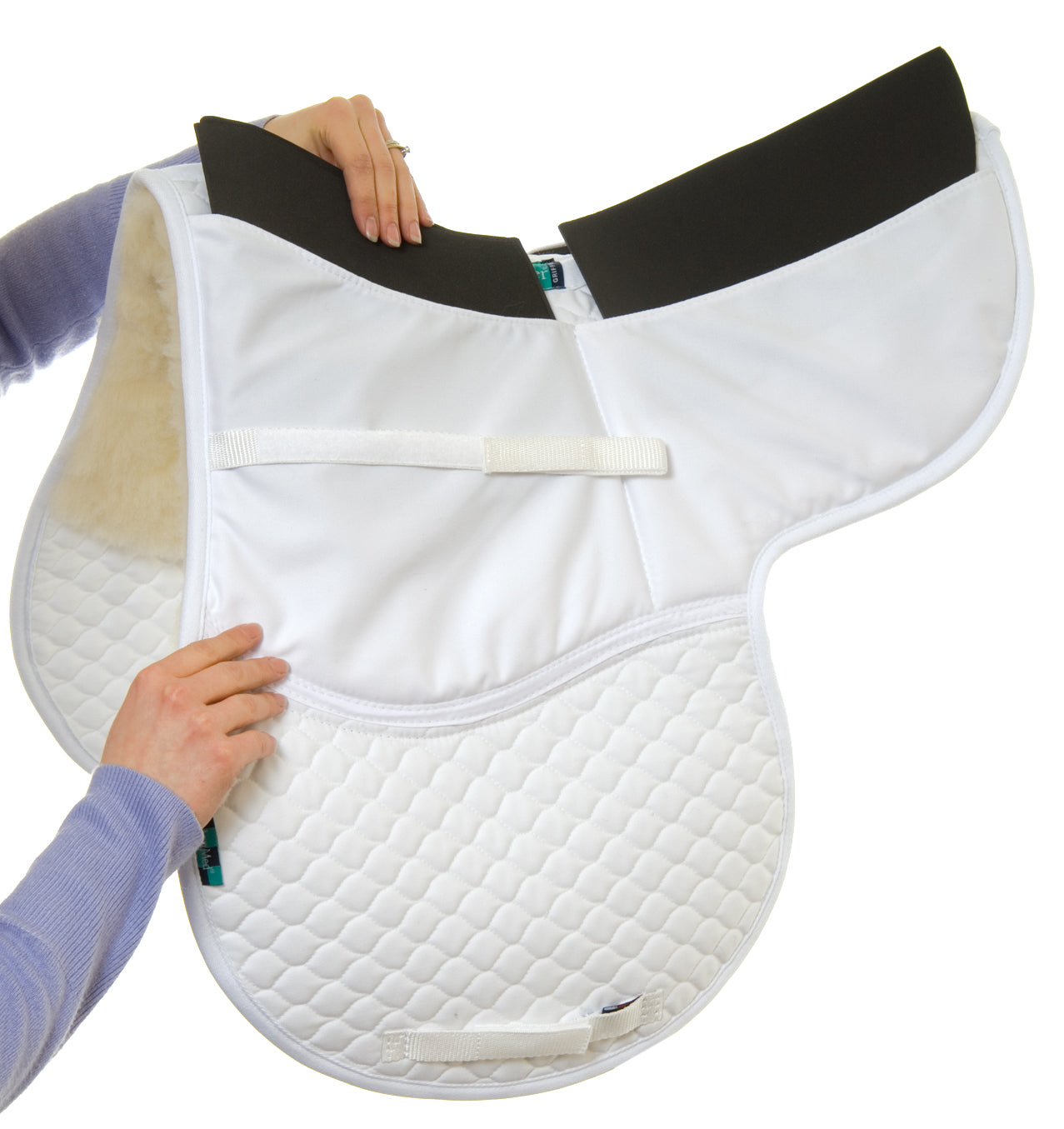 Demonstration image of shim panels being inserted into a white NuuMed Corrective 2 Pocket Full Wool GP Numnah